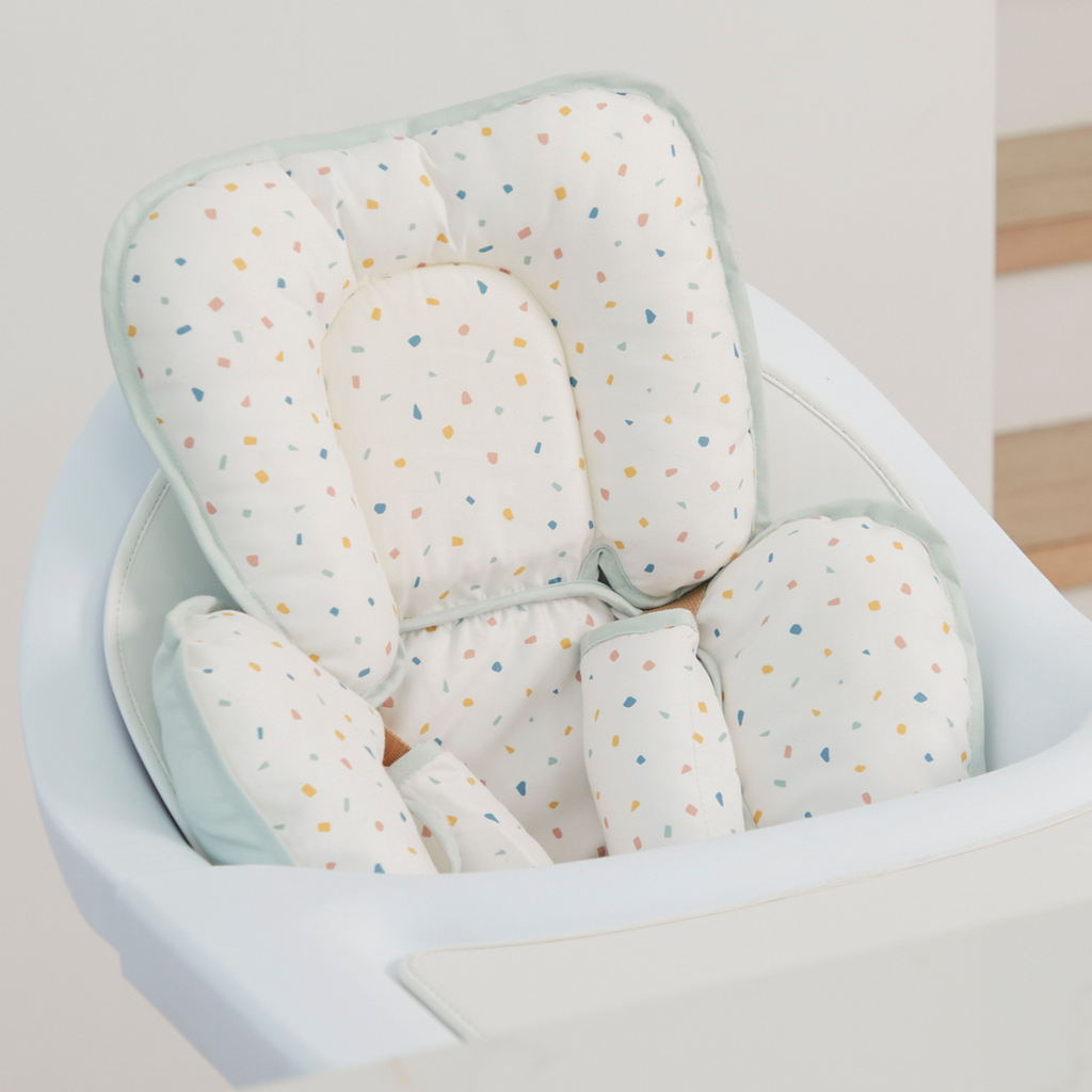 Padded baby high chair insert cushion with head and body support – soft cotton fabric featuring colorful confetti dot pattern for added comfort and safety.