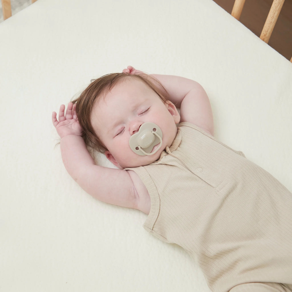 Baby sleeping peacefully on ClevaFoam Support Mattress