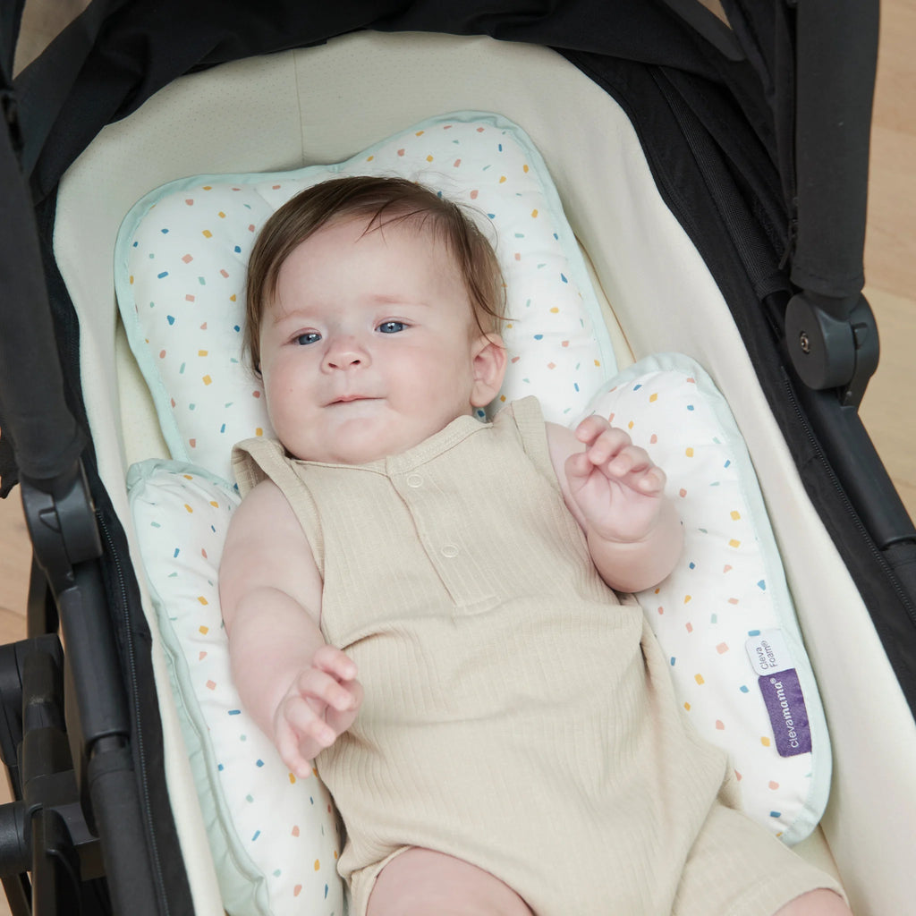 Baby lying in bassinet with ClevaMama head & neck support.