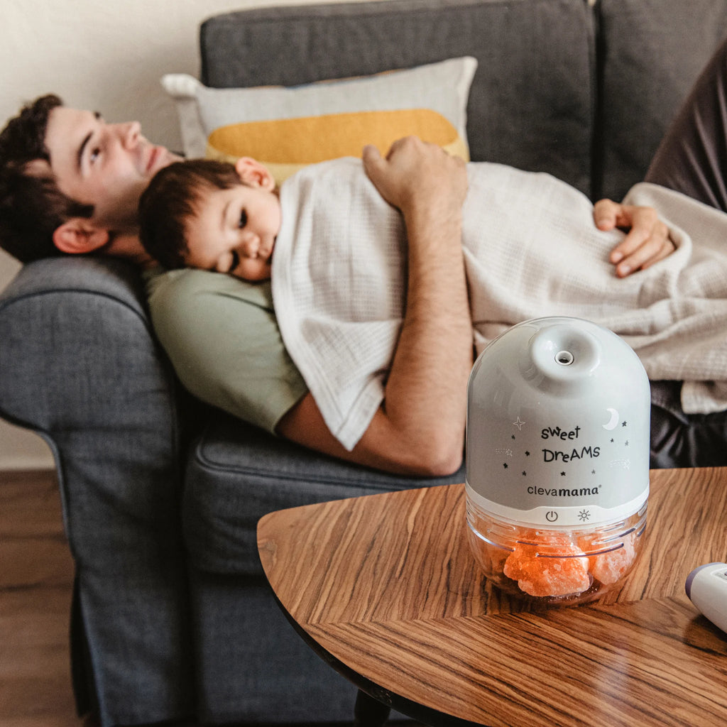 ClevaPure salt lamp humidifier diffuser night light glowing in living room beside father and child.